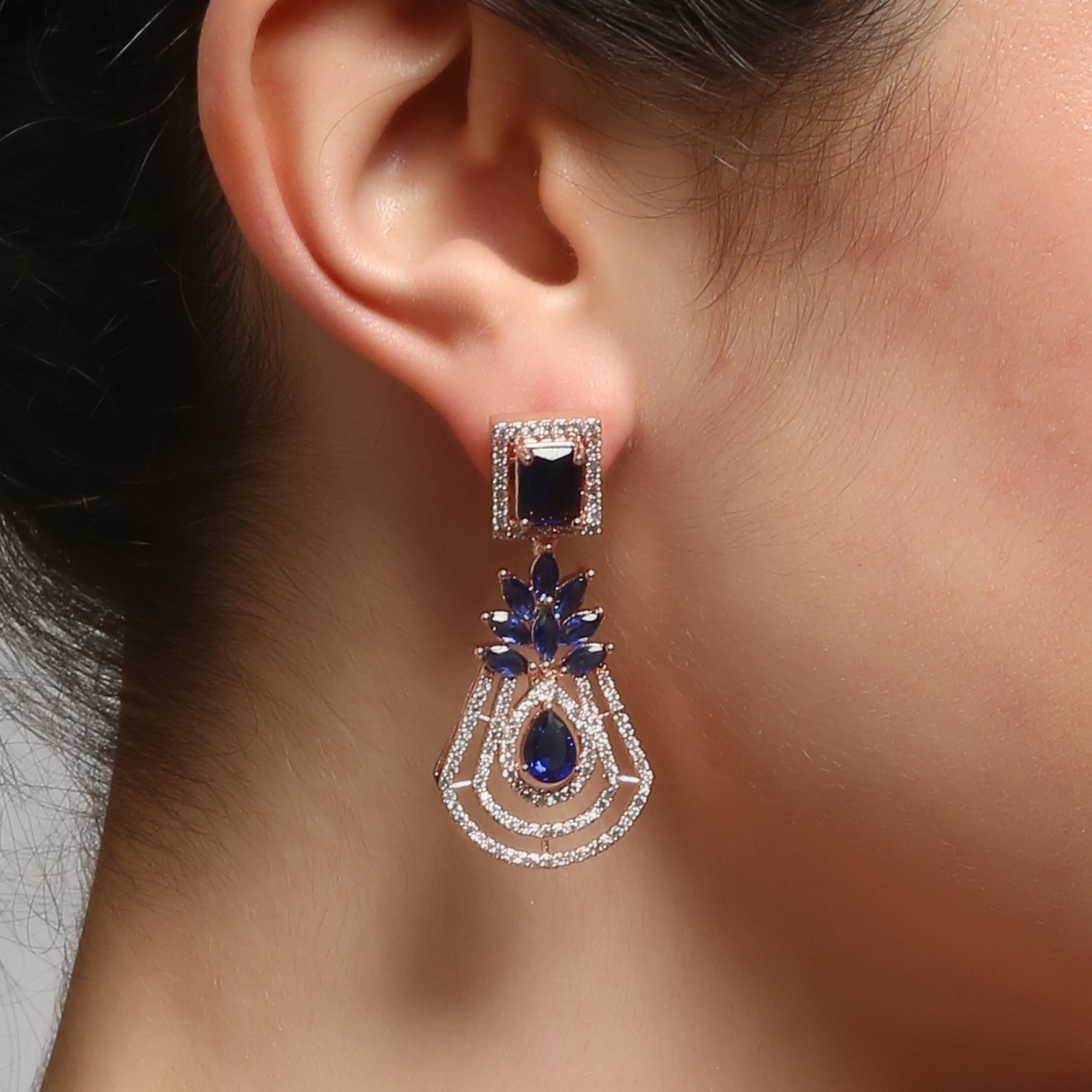 Handcrafted rose gold plated blue dangler american diamond earrings