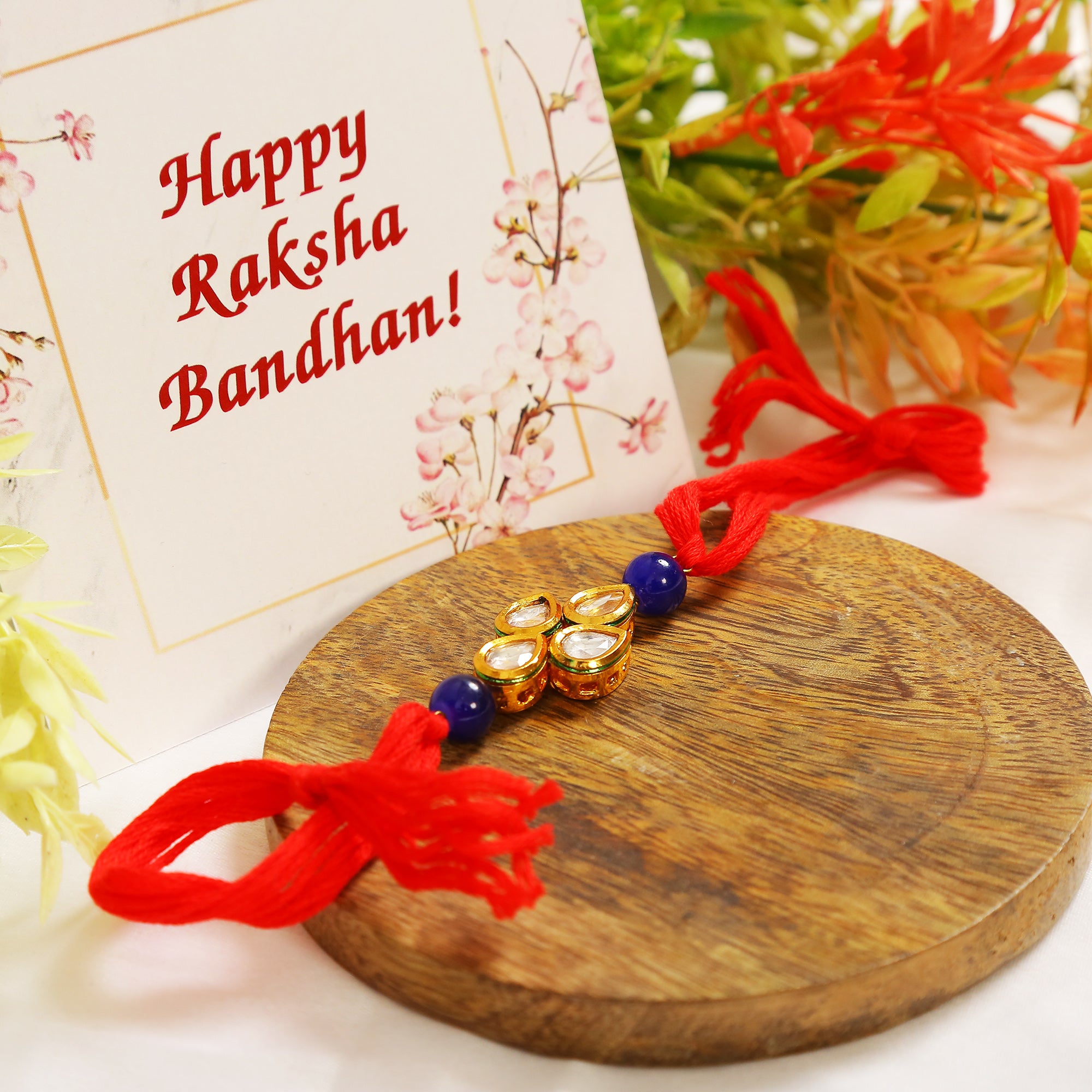 Red Gold toned blue beaded Kundan rakhi