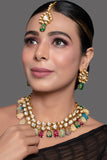 Gold toned multicolored beaded kundan necklace teamed with matching earrings & Maang Tikka