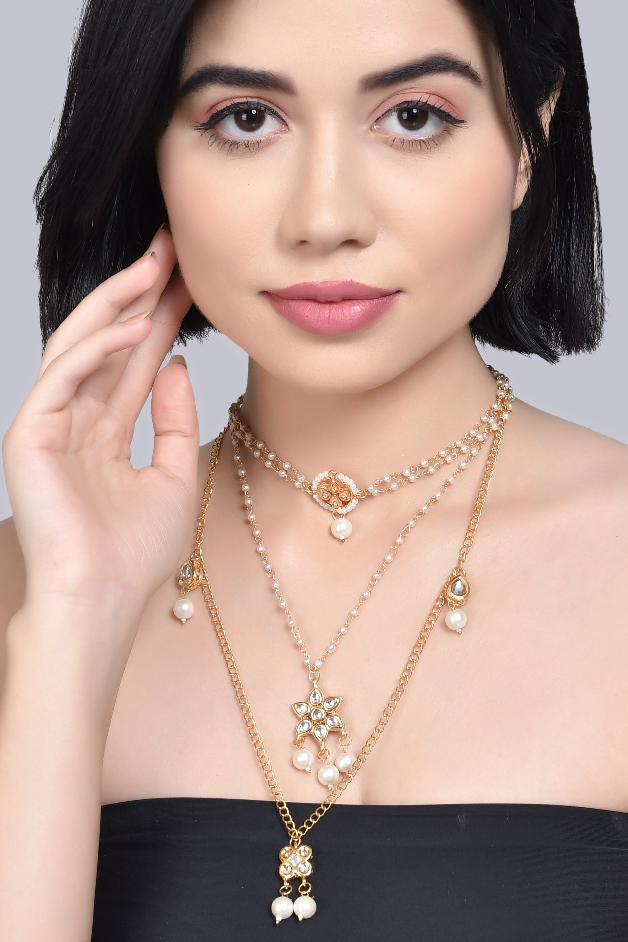 Multilayered pearl beaded Kundan embellished necklace teamed with choker