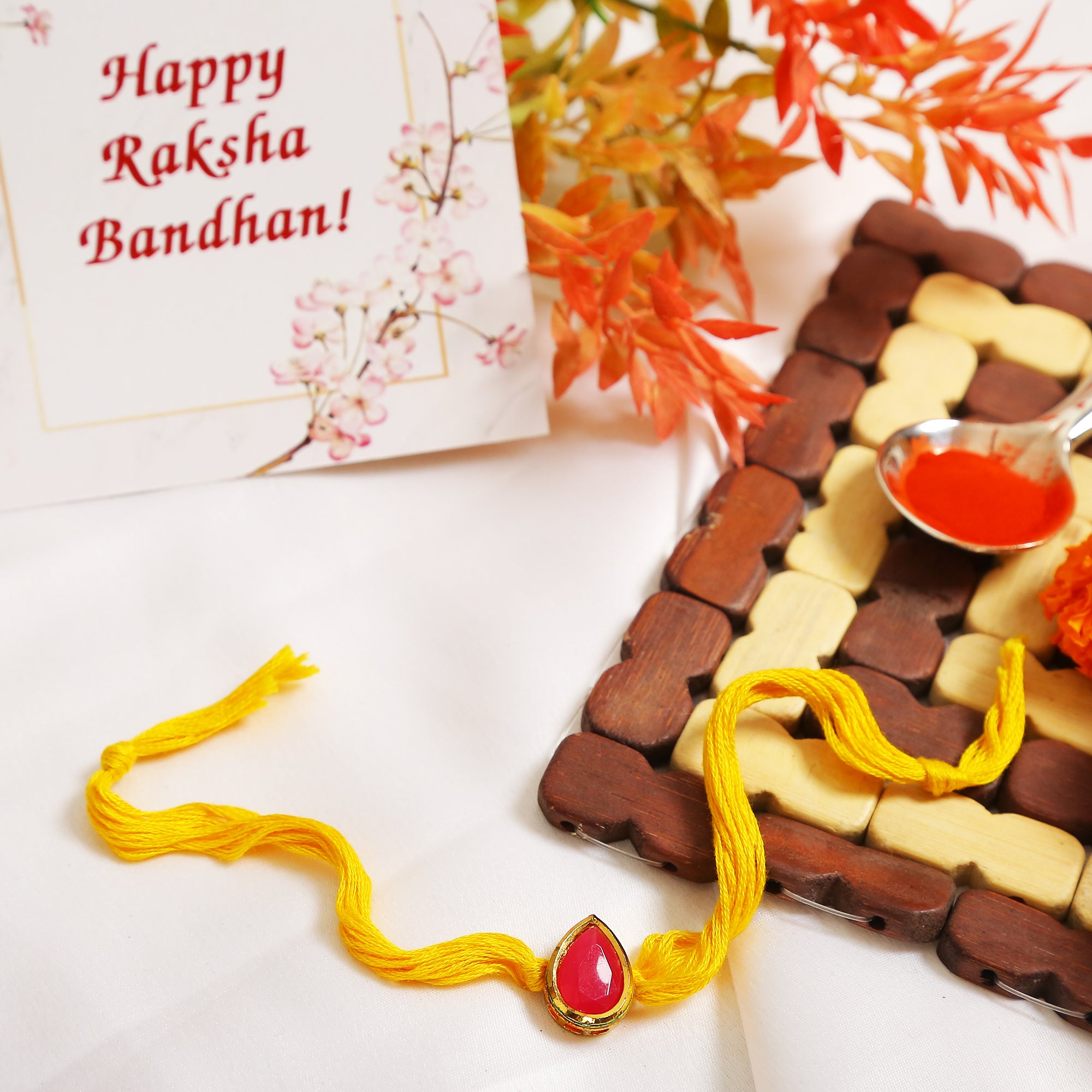 Red Gold Tone Kundan Rakhi with yellow thread