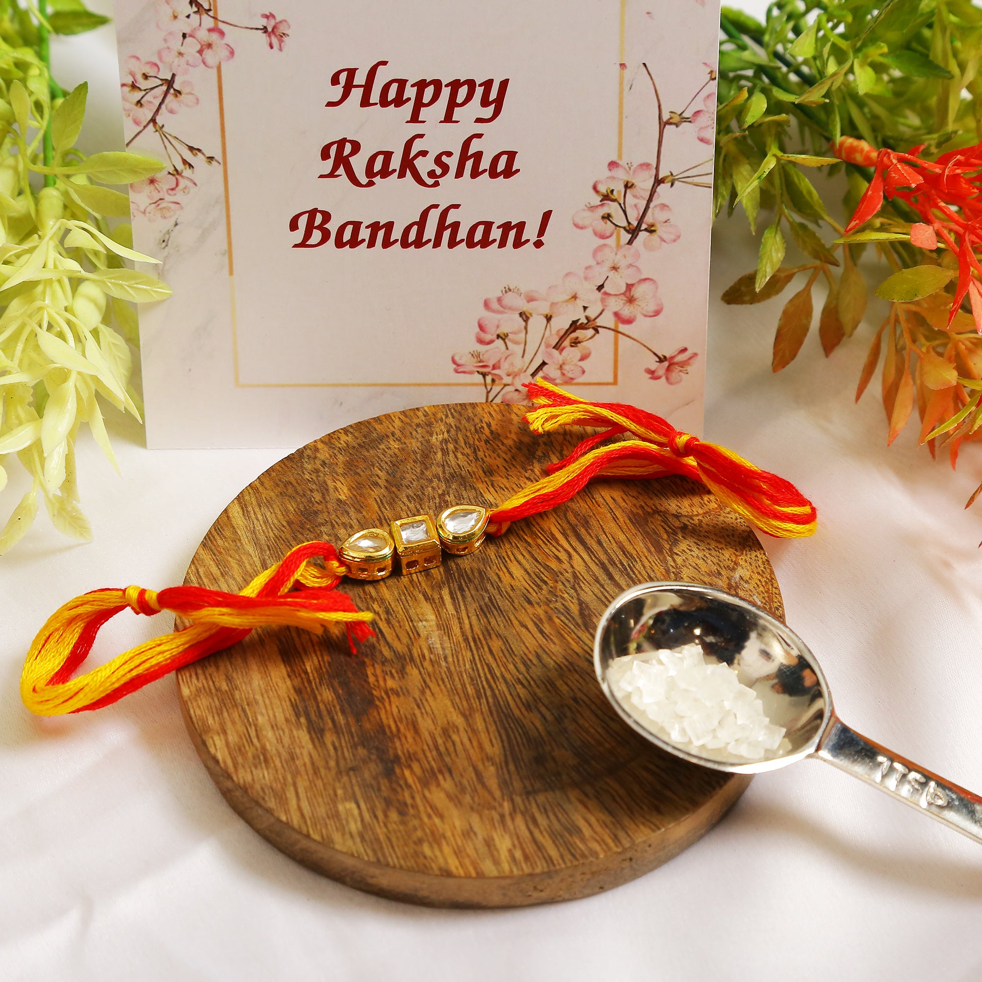 Gold Tone Kundan Rakhi with red yellow cotton thread