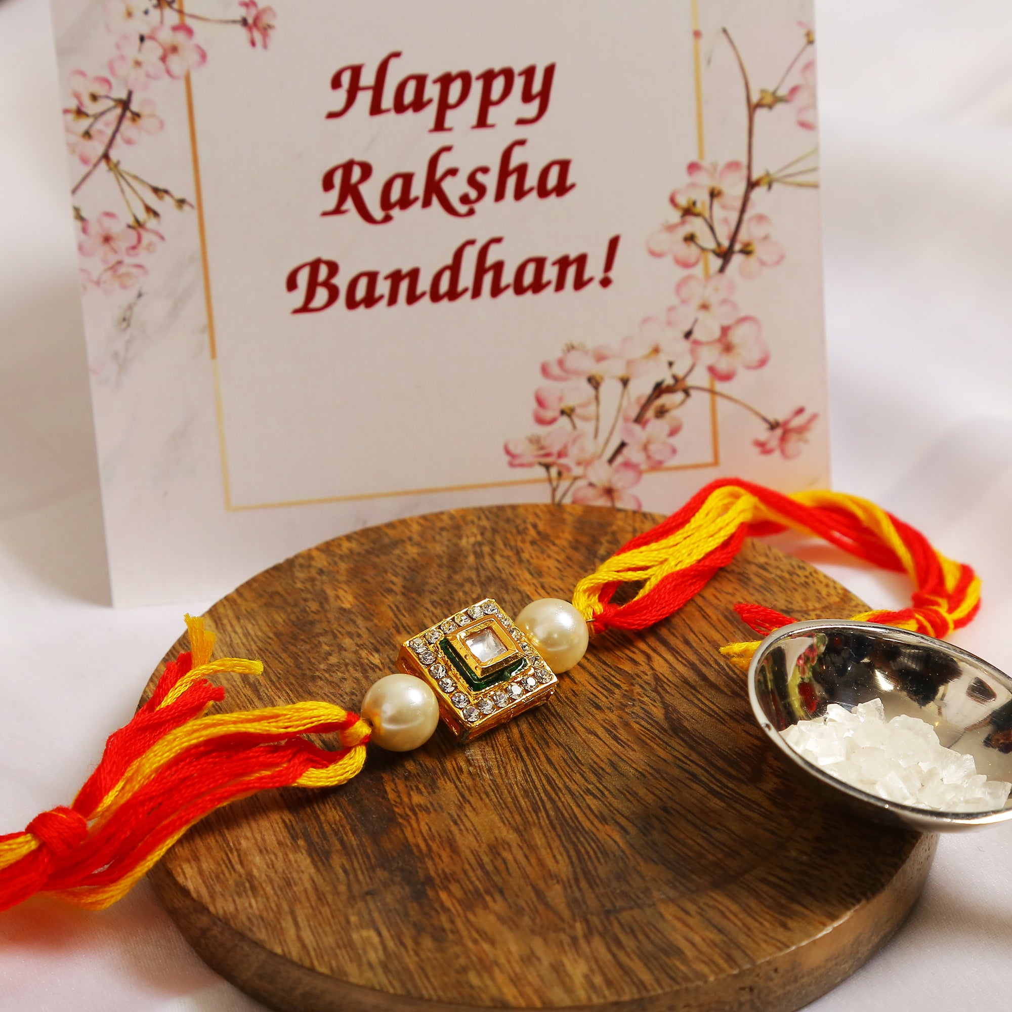 High quality Kundan studded rakhi with yellow cotton thread