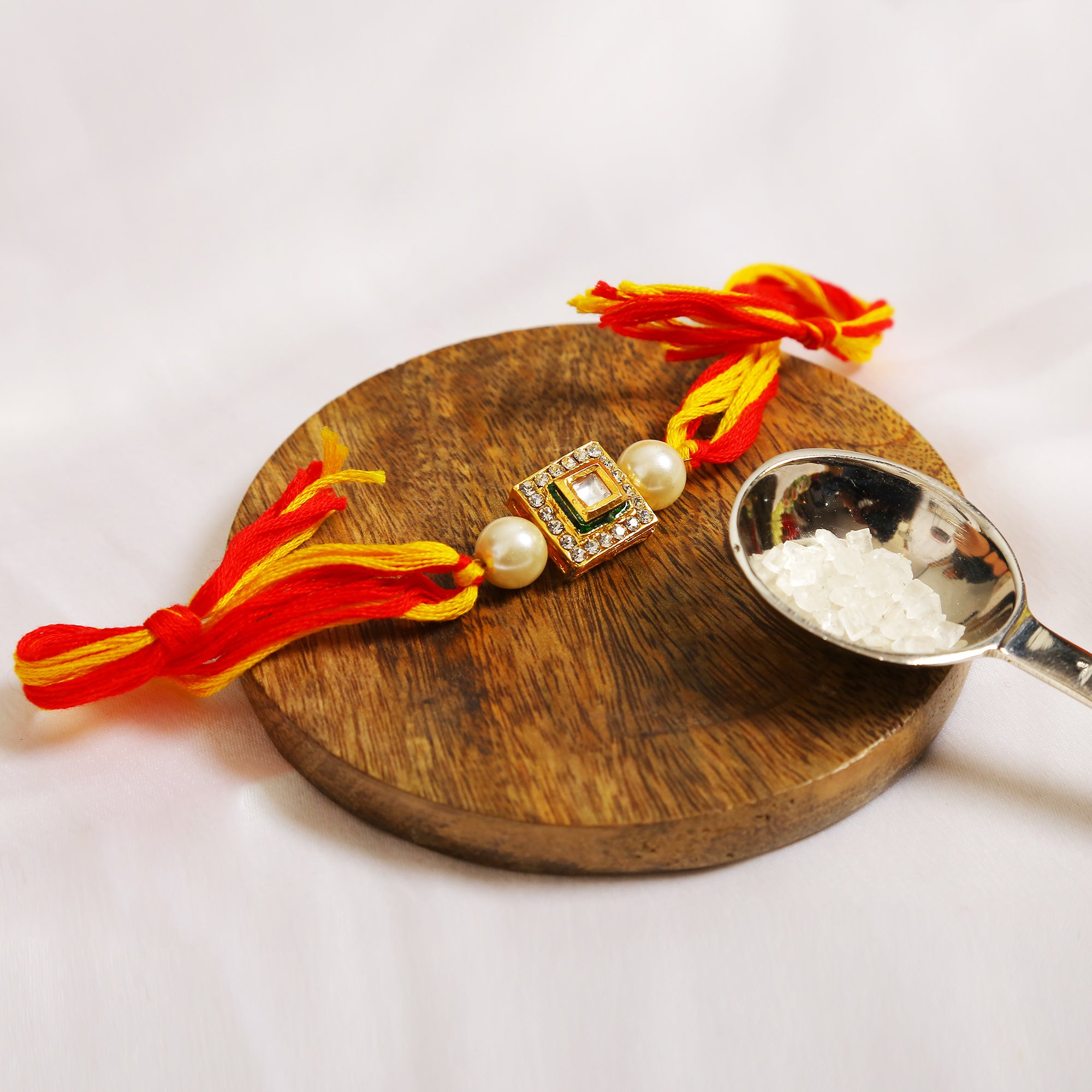 High quality Kundan studded rakhi with yellow cotton thread