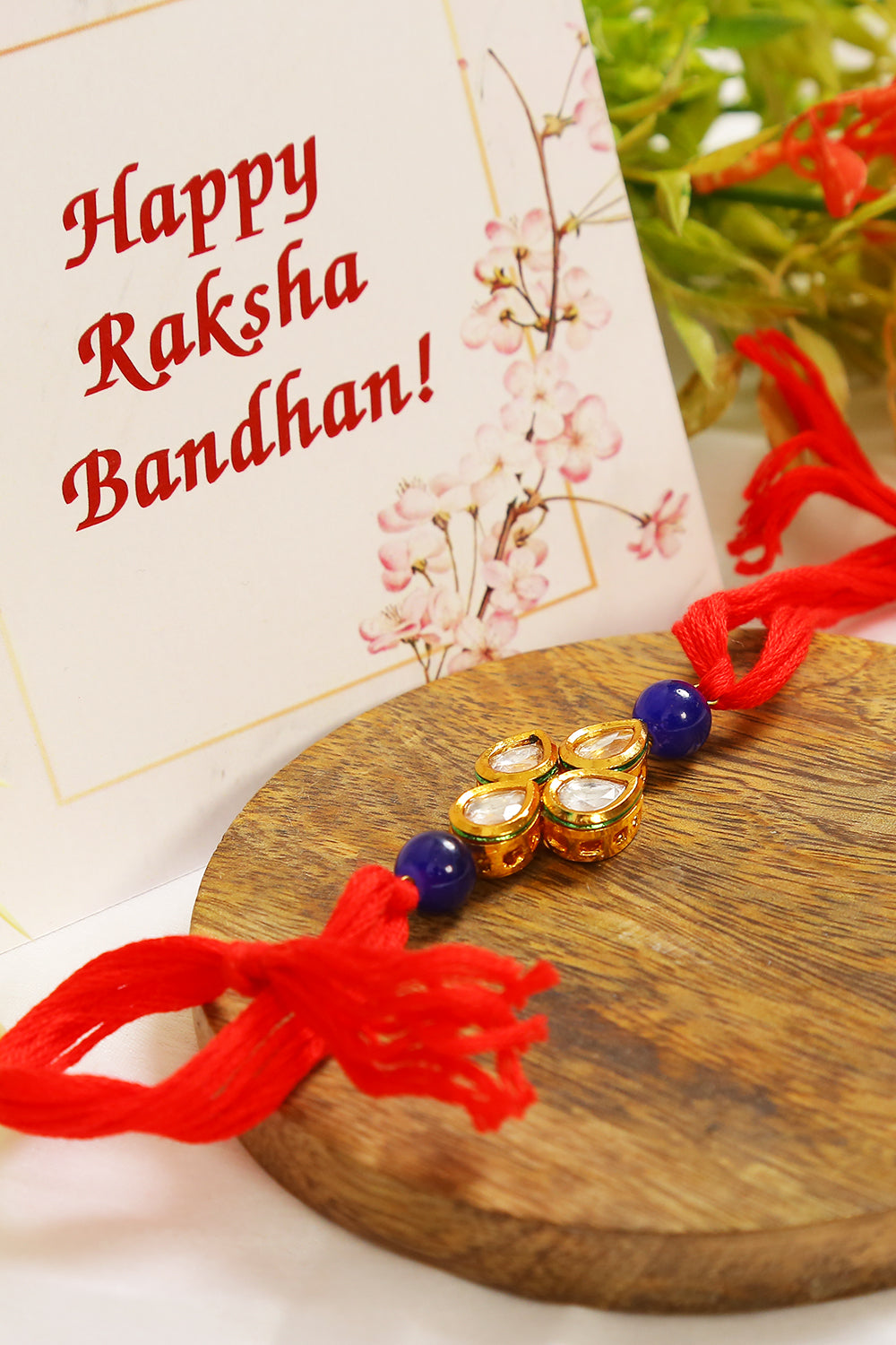 Red Gold toned blue beaded Kundan rakhi
