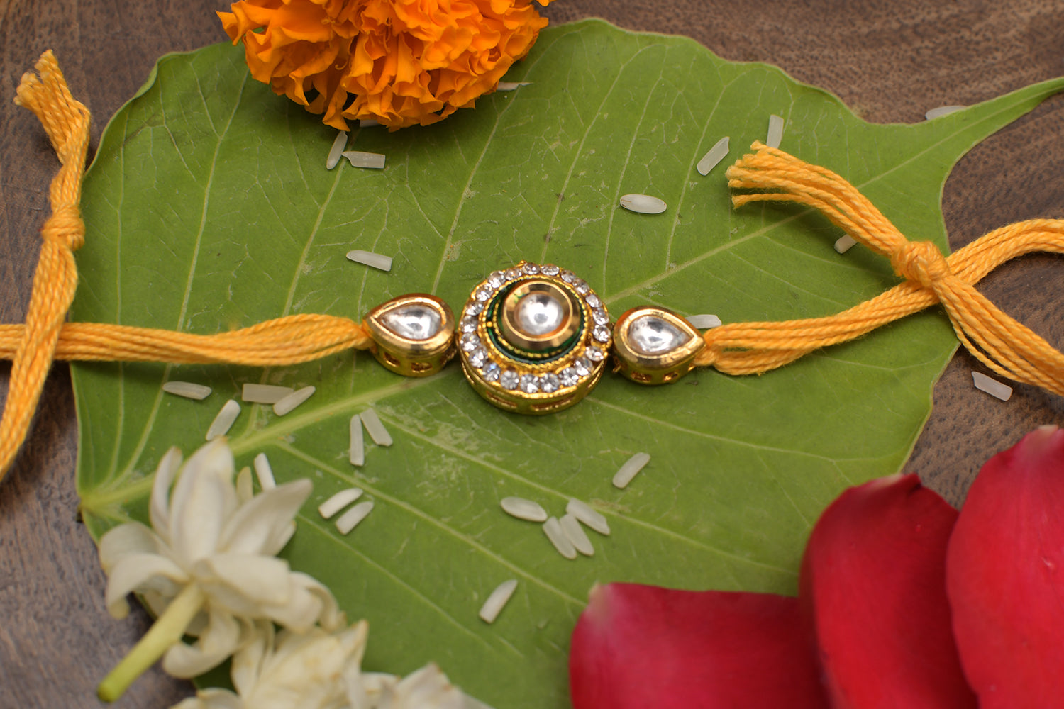 High quality Kundan studded rakhi with yellow cotton thread
